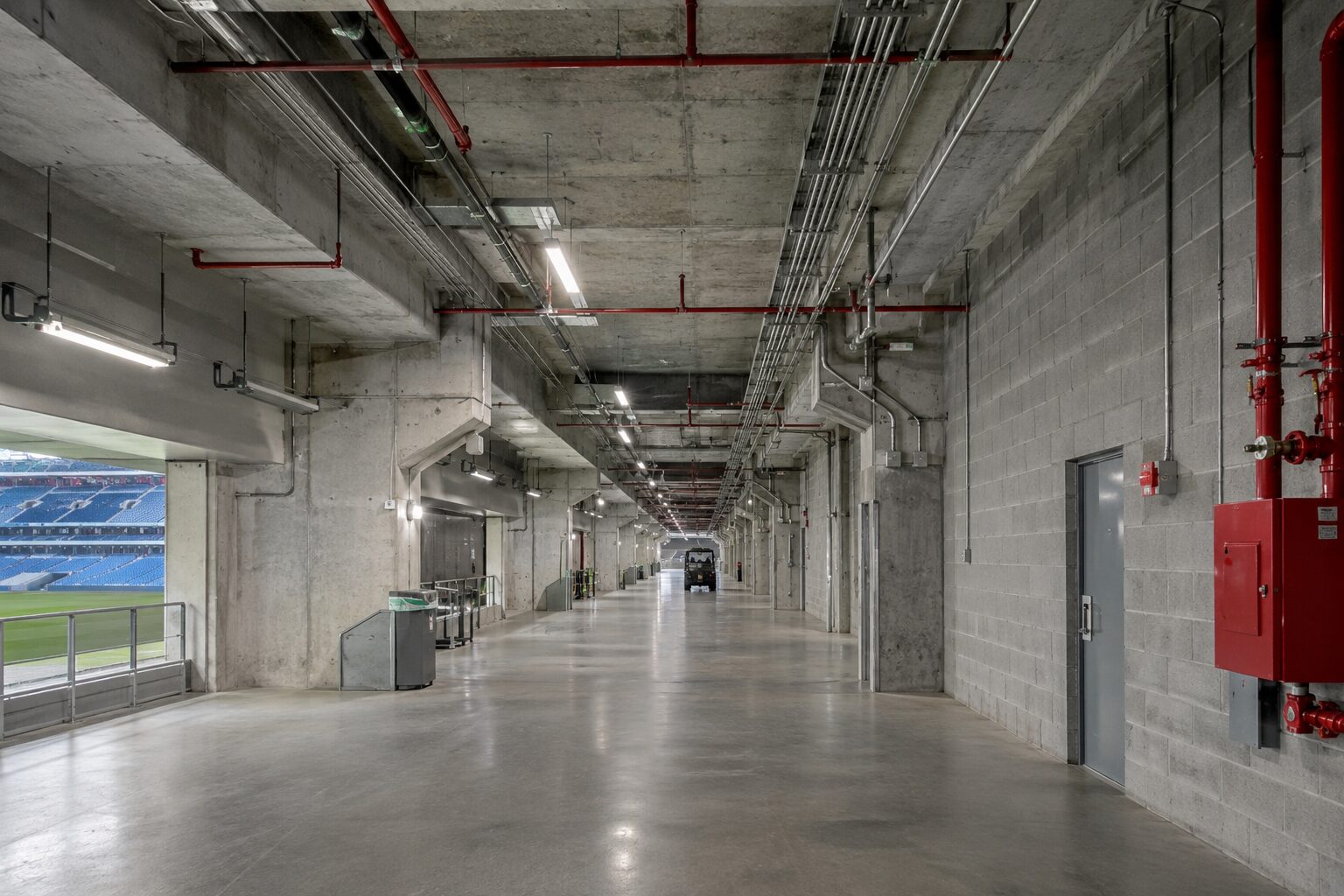 Stadium corridor with fire sprinkler piping and safety systems in Florida